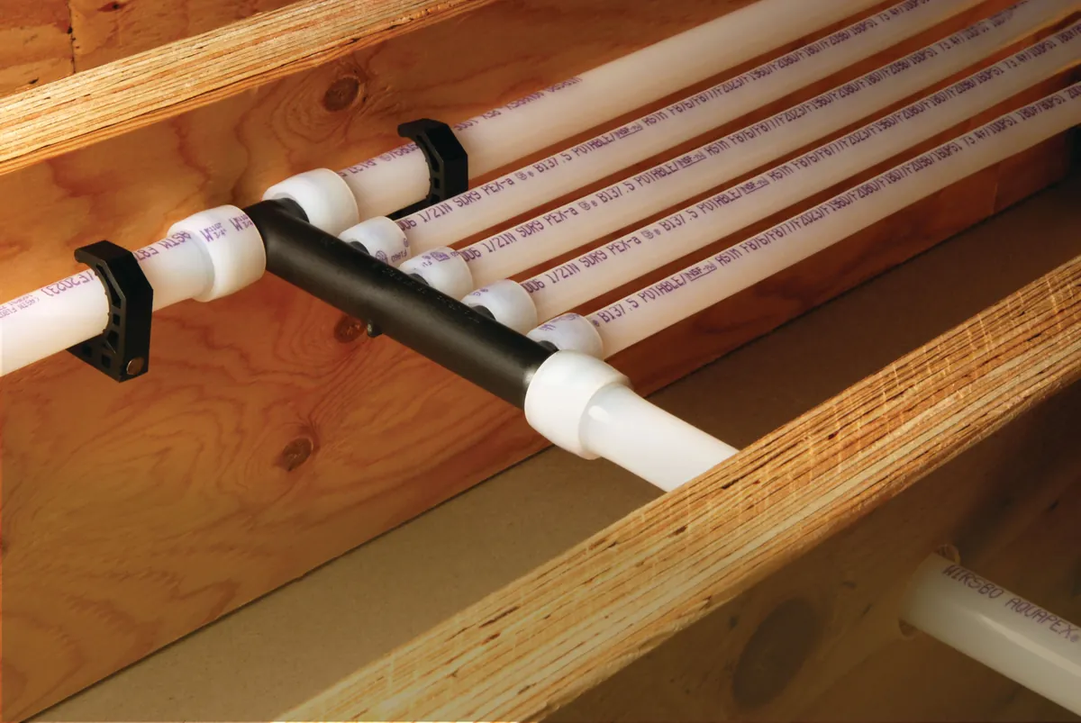 PEX-A multiport tee distributing water lines along joists – Navien Tankless Water Heater Installation for Costa Mesa, CA homes